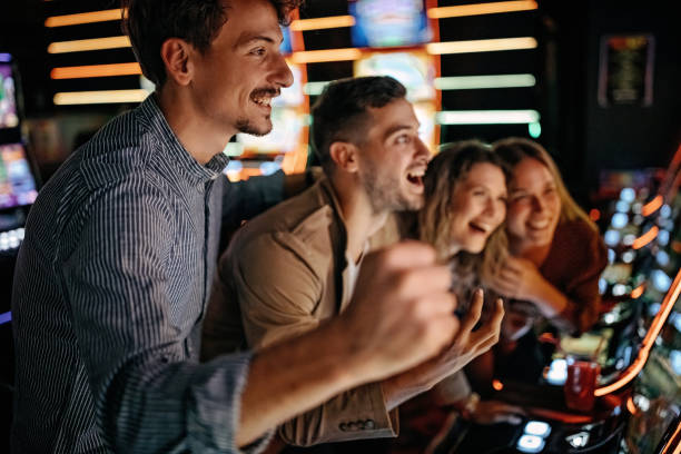Friends gambling in casino on slot machinery